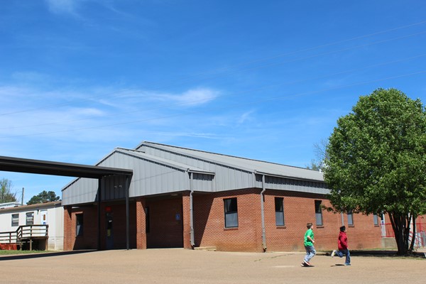 Students running by building on a sunny day